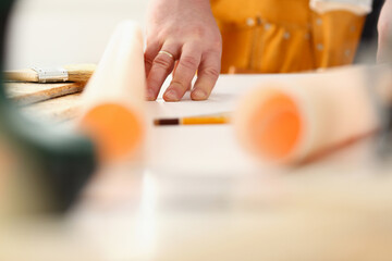 Arms of worker making structure plan on scaled paper closeup. Manual job, DIY inspiration, improvement job, fix shop graphic, joinery startup, workplace idea, designer career, industrial education