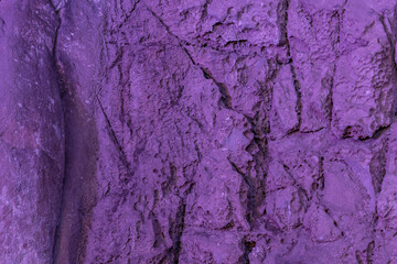 Closeup of markings cut into limestone wall lit by artificial maroon light in small cave located near Sintanjin, South Korea.