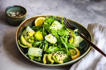 Healthy vegetable salad with aragula and avocado