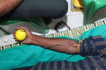 Blood donor at donation with a bouncy ball holding in hand stock photo