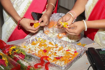 Obraz na płótnie Canvas girls prepare flowers for special ones in india stock photo