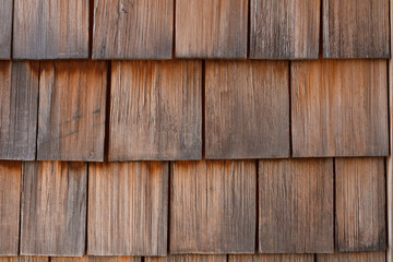 Wood texture, old wood shingles background, shingle roof and house facade.
