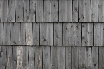 Wood texture, old wood plank shingles background, shingle roof and house facade.