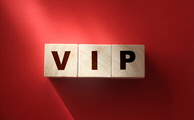 VIP Very Important Person text on wooden cubes on red. Business concept