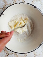 woman mixing sugar and butter for baking muffins