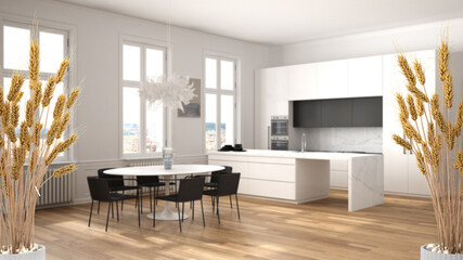 Potted straws with pebbles, dry plants, ornament, ears, sheaf, branch in vase over wooden and white kitchen with accessories, modern minimal interior design