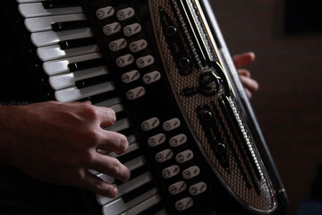 Close up of hands playing accordion
