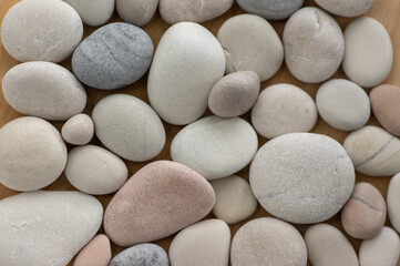 Fototapeta na wymiar White, gray and pink pebbles simple background, simplicity stones one by one
