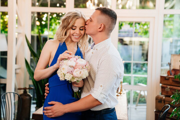 pair of lovers. girl with bouquet of flowers donated in honor of engagement.
