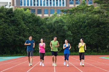Group of friends running together outdoors