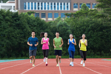 Fototapeta premium Group of friends running together outdoors