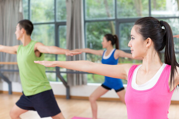 Group of young people doing exercise in the gym