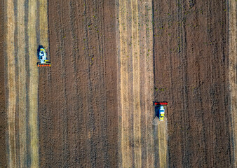 Harvesting time. Agricultural industry. Aerial view of combine harvester in field. Top view