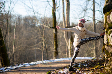 Yoga outdoor. Happy woman doing yoga exercises. Yoga meditation in nature. Concept of healthy lifestyle and relaxation.