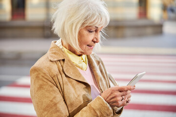 Professional headshot of a middle aged woman walking in city
