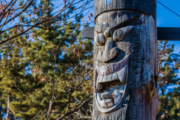 Carved face of wooden totem pole