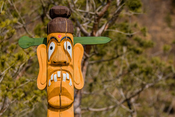 Carved face of wooden totem pole