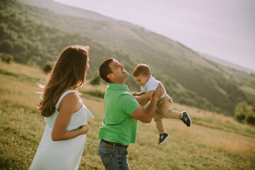 Young family having fun outdoors in the field