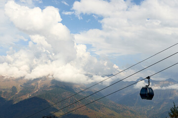 Nature and travel concept - funicular in the high mountain and sky with clouds in autumn. Beautiful landscape