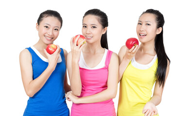 Young Asian women eating apple after exercise in the gym