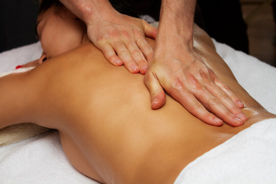 Photo of medical back massage. Relaxing treatments for women.