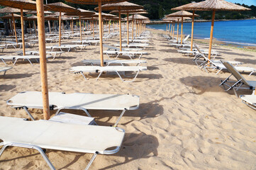 beach umbrellas and sun loungers on an empty beach