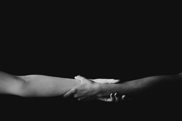 white and black hand together