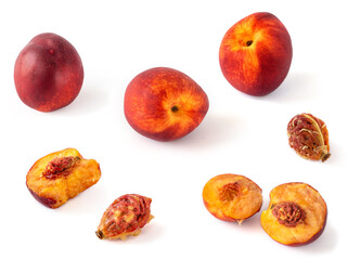 Whole, broken, nibbled nectarines and seeds isolated on a white background. Fruit background with nectarines.