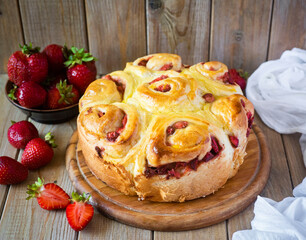 Strawberry pie on a wooden platter on a wooden table