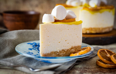 A slice of lemon cheesecake on a plate on a wooden table