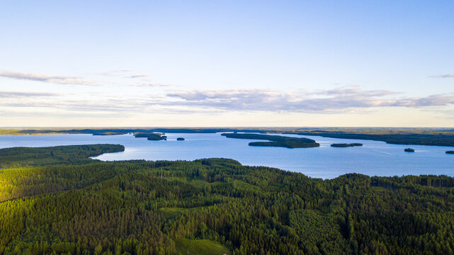 Scenic rural landscape shot over the forest and lake with sunshine. Lake Pyhäjärvi, Finland.