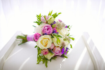 Closeup view wedding bouquet of flowers from freshly cut roses and other beautiful flowers in the composition