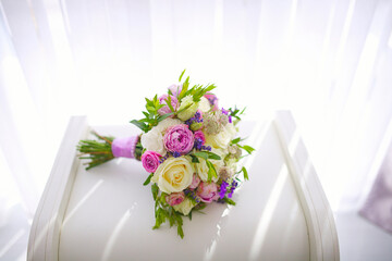 Wedding bouquet of flowers from freshly cut roses and other beautiful flowers in the composition