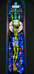 Decorative stained glass with motives from Christian religion used on windows in catholic church in...