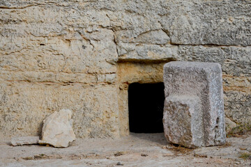 The cave is coffin for burial according to the ancient Jewish tradition. Large stone at the...