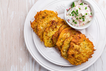 Fried potato pancake with dip of radishes cream cheese and chives