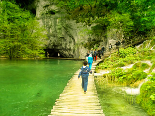 Tourists on walking trail at Plitvice Natural Park in Plitvice, Croatia.   