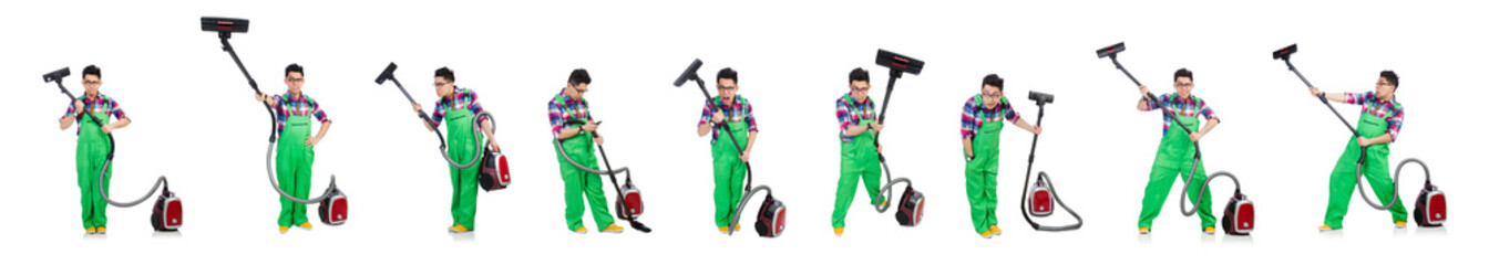 Funny man in green coveralls vacuum cleaning