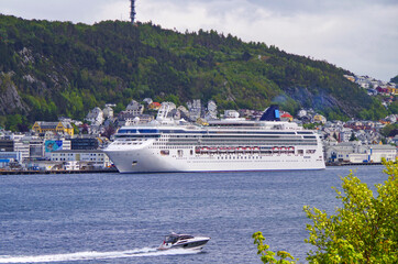 Modern white cruiseship or cruise ship liner in port of Alesund in Norway during Norwegian cruising...