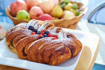 Apple pie decorated with fresh berries on a blurred background. Bokeh.