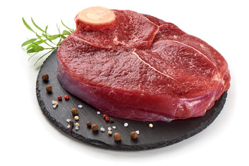 Fresh raw beef meat with bone for steak on stone plate, isolated on white background