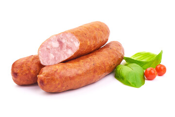 Delicious Smoked Sliced Sausages with Basil leaves, isolated on a white background. Close-up.