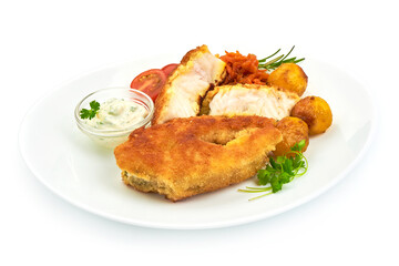 Crispy breaded fish fillet with herbs, sauce and tomatoes, isolated on a white background. Close-up