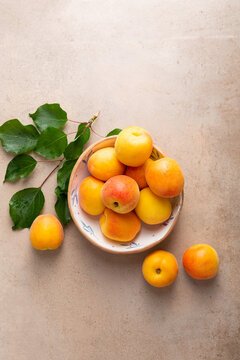 Overhead view of fresh yellow apricot on stone table © Olha Afanasieva