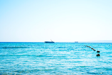 Travel boat on the horizon at the sea.