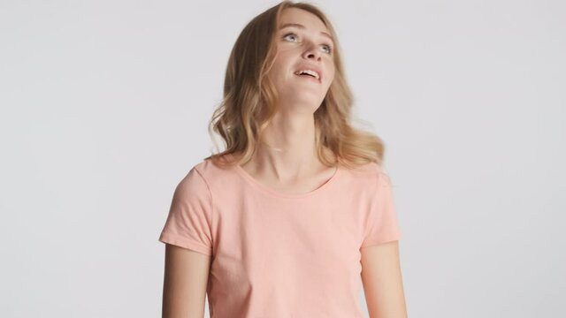 Young attractive funny woman showing wait gesture on camera over gray background. Wait a minute expression