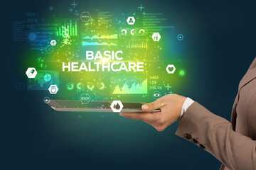 Close-up of a touchscreen with BASIC HEALTHCARE inscription, medical concept