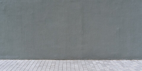 dark gray concrete wall exterior with empty space for mockup over block cement pavement outdoor