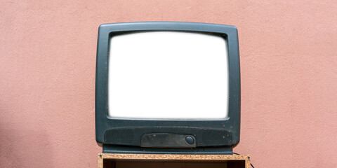 old vintage retro tv with white blank screen for mock-up on wooden stand aged pink wall background