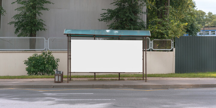 empty bus stop with blank white billboard for commercial information advertising concept